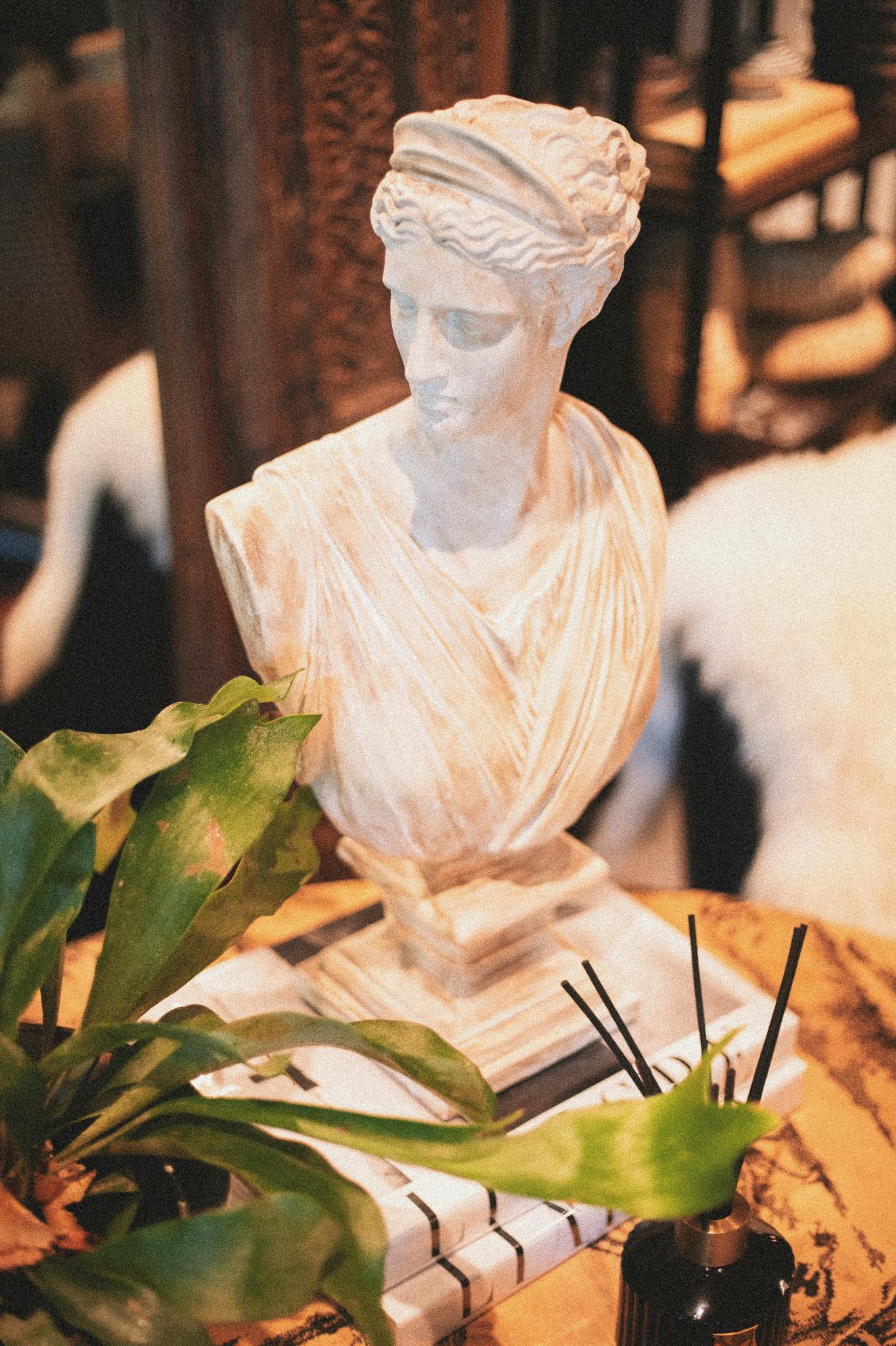 Marble bust elegantly styled among artisan decor in a Greenville boutique, showcasing classic interior design elements.